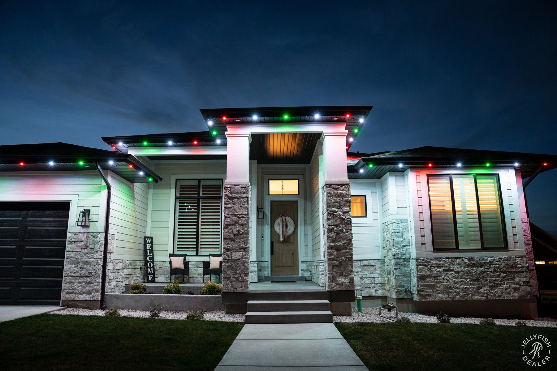 Red, green and white lights on a modern home.