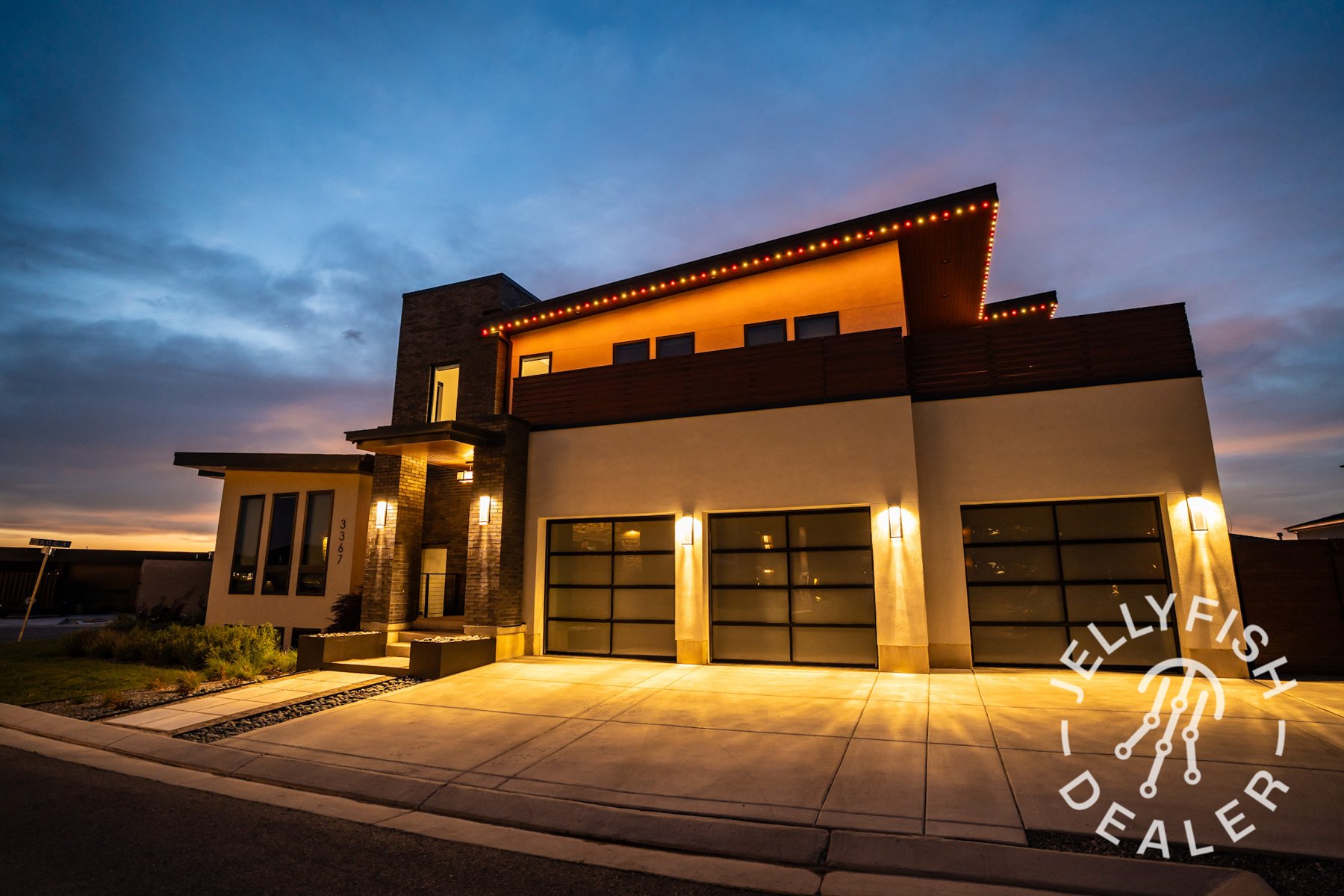 Warm golden lighting on a modern flat-roof home at dusk.