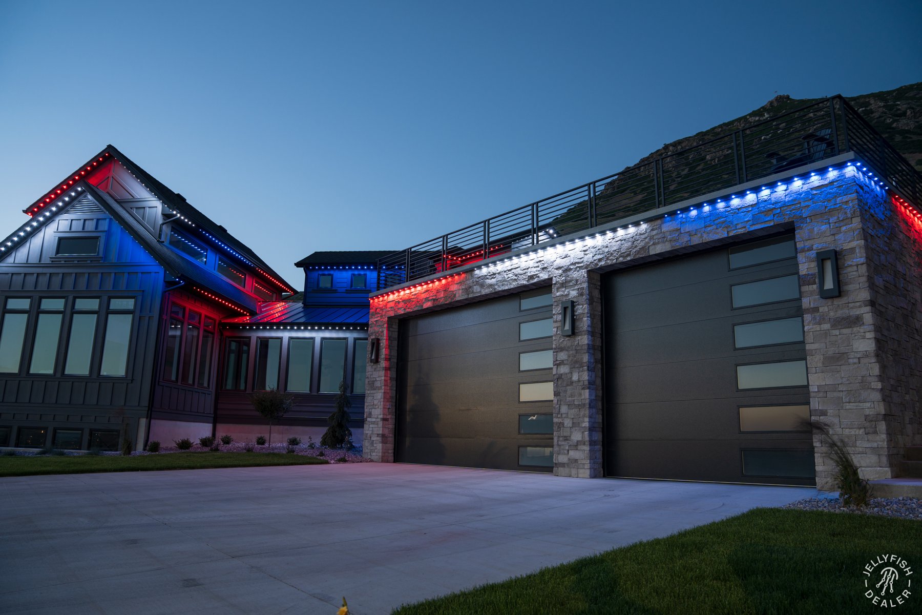 Red, white and blue lights along a farmhouse garage.