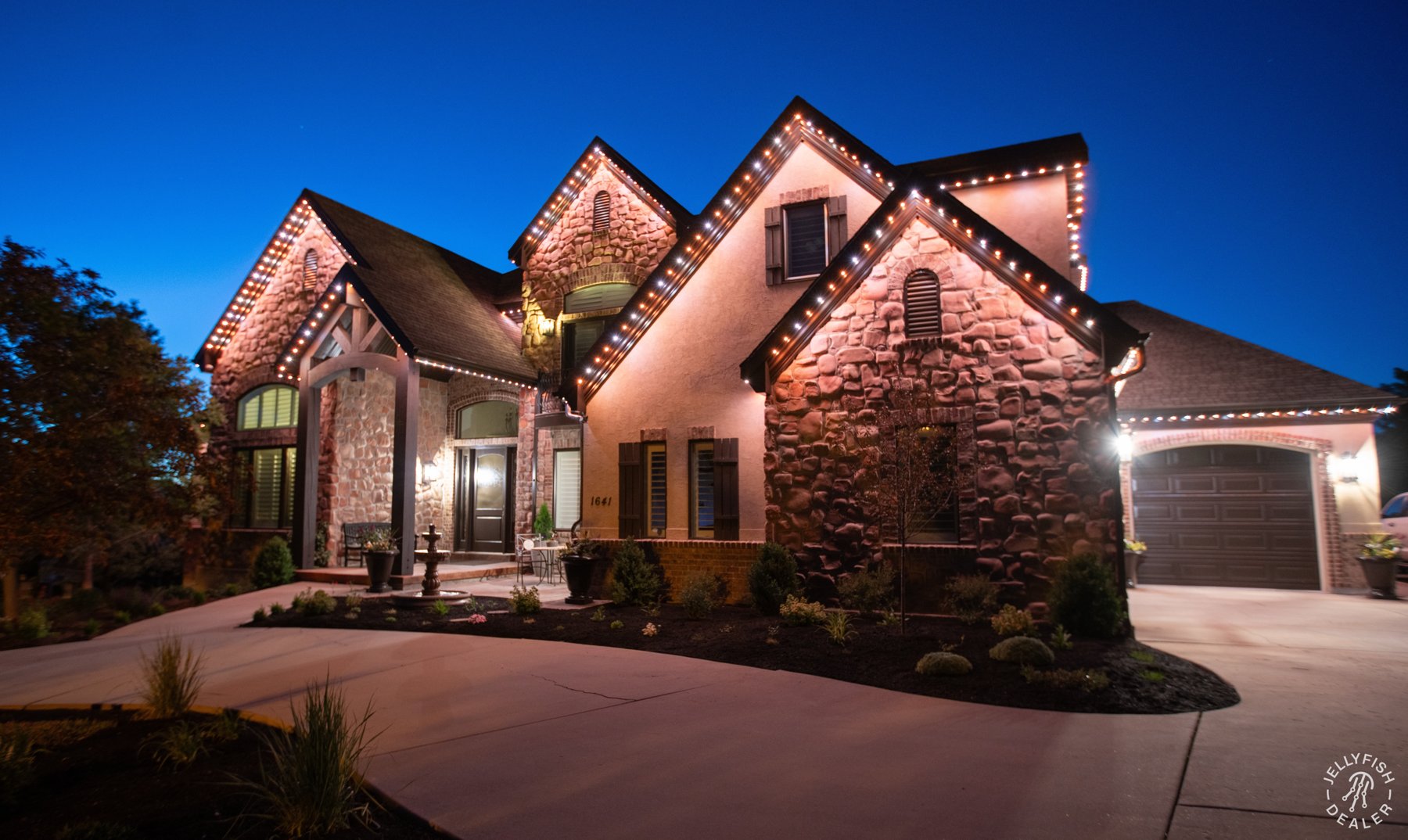Orange and white roofline colors on a stone home.