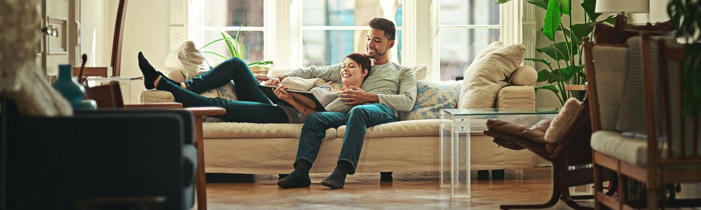 Family relaxing in a living room with connected home technology.