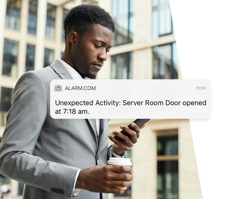 Business owner receiving an Alarm.com restricted-door activity alert.