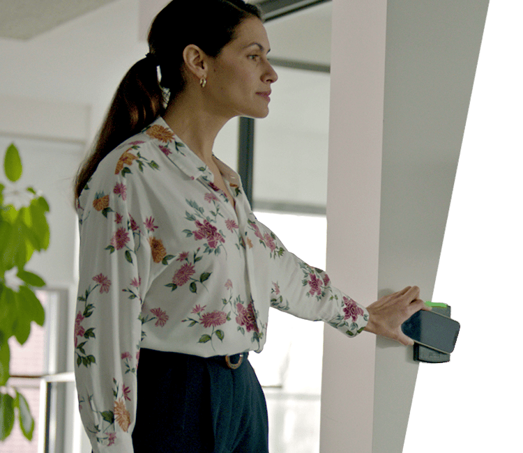 Person presenting a mobile credential to an access reader.