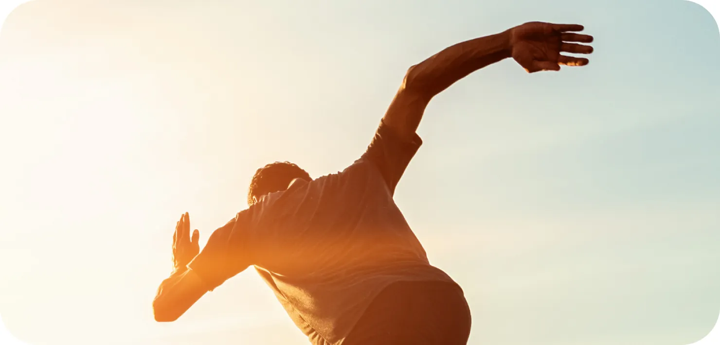 Athlete stretching at sunset