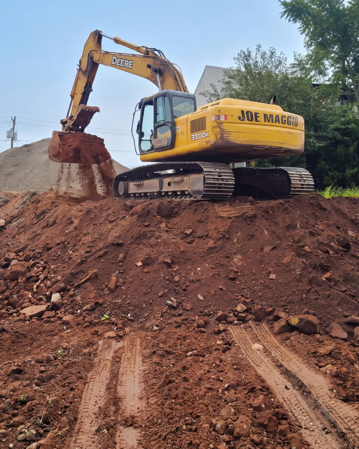Joe Maggio Construction excavator performing excavation and site work for commercial site preparation in New Jersey.