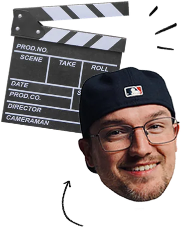 Man wearing glasses and a dark baseball cap smiling, positioned in front of a black and white movie clapperboard.