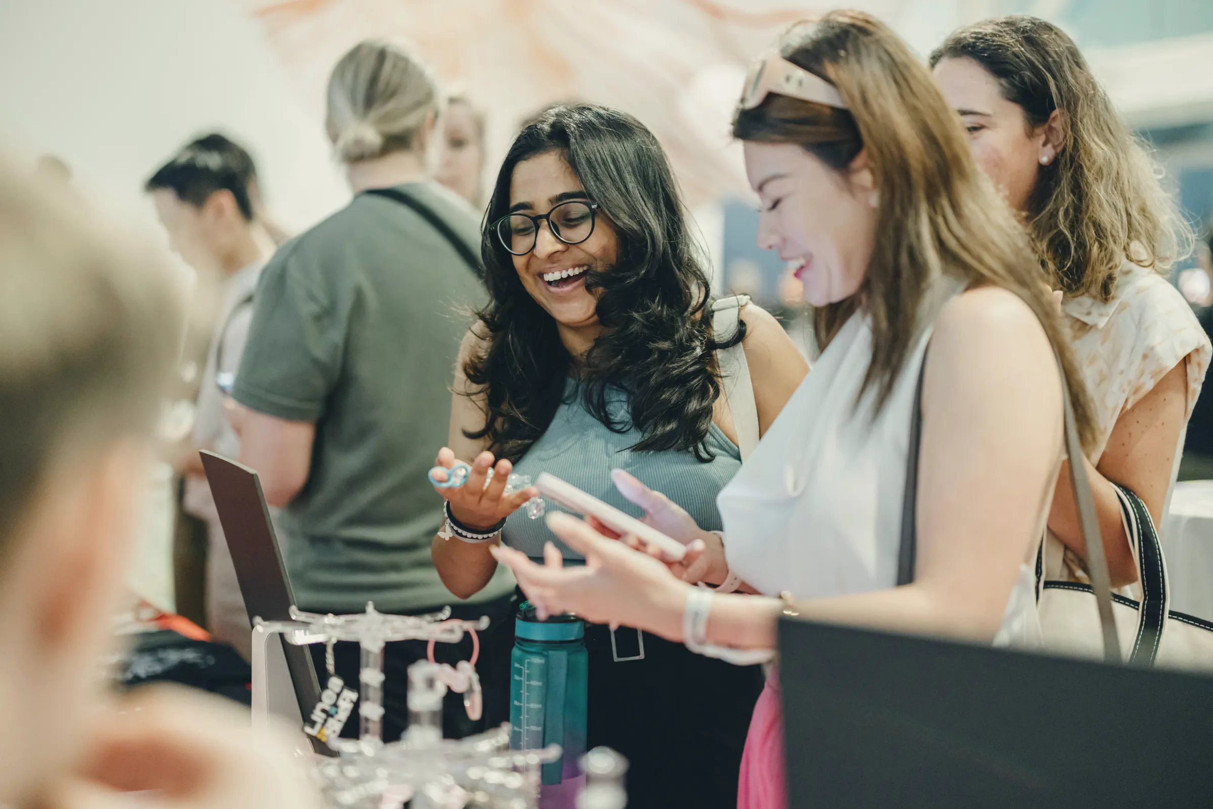 People chatting and laughing at an event stall