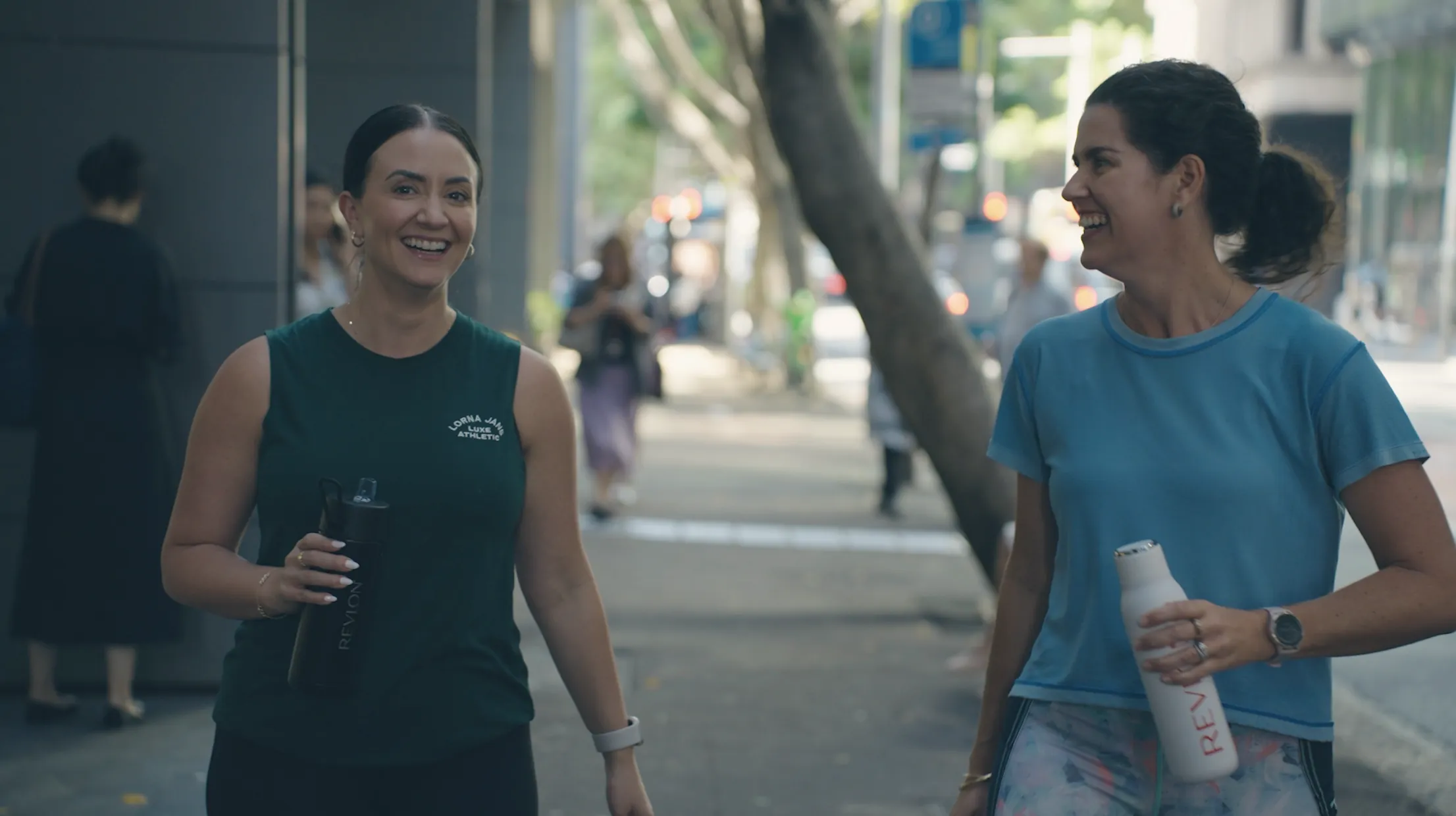 Two Revlon colleagues laughing as they walk outside