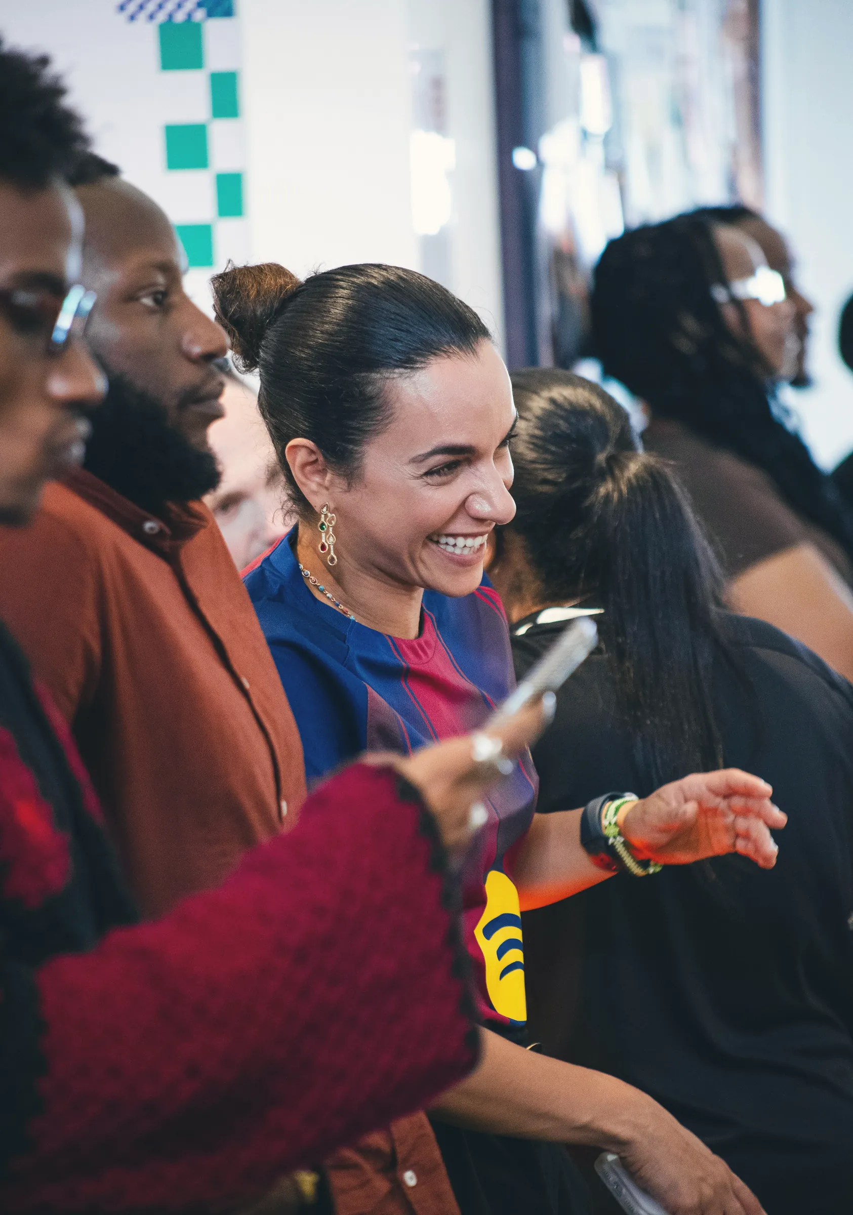 Woman smiling in a crowd at a work event