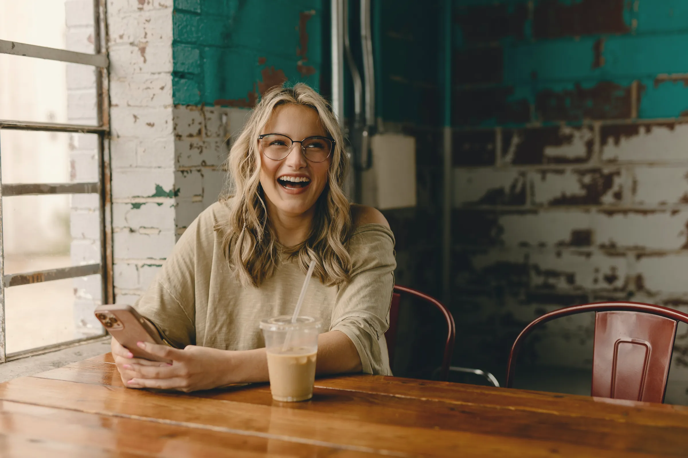 Woman laughing in a cafe
