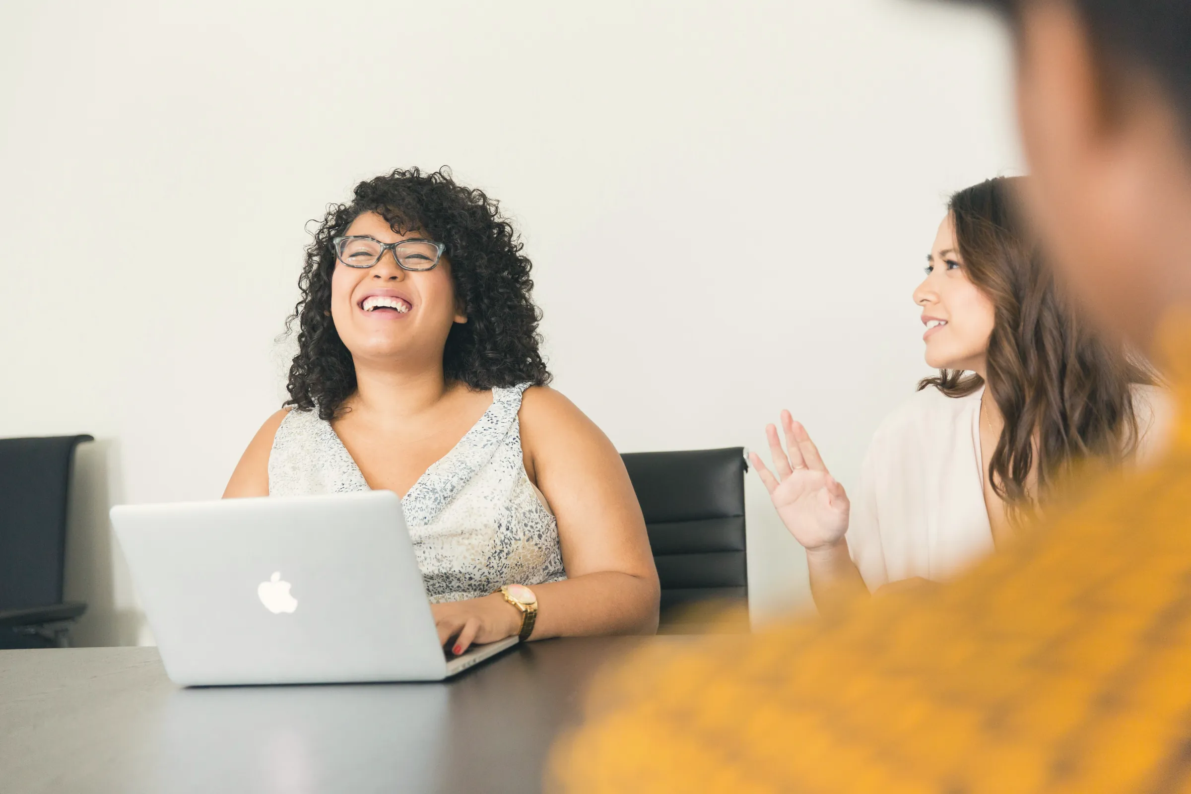 Colleagues laughing during a team meeting