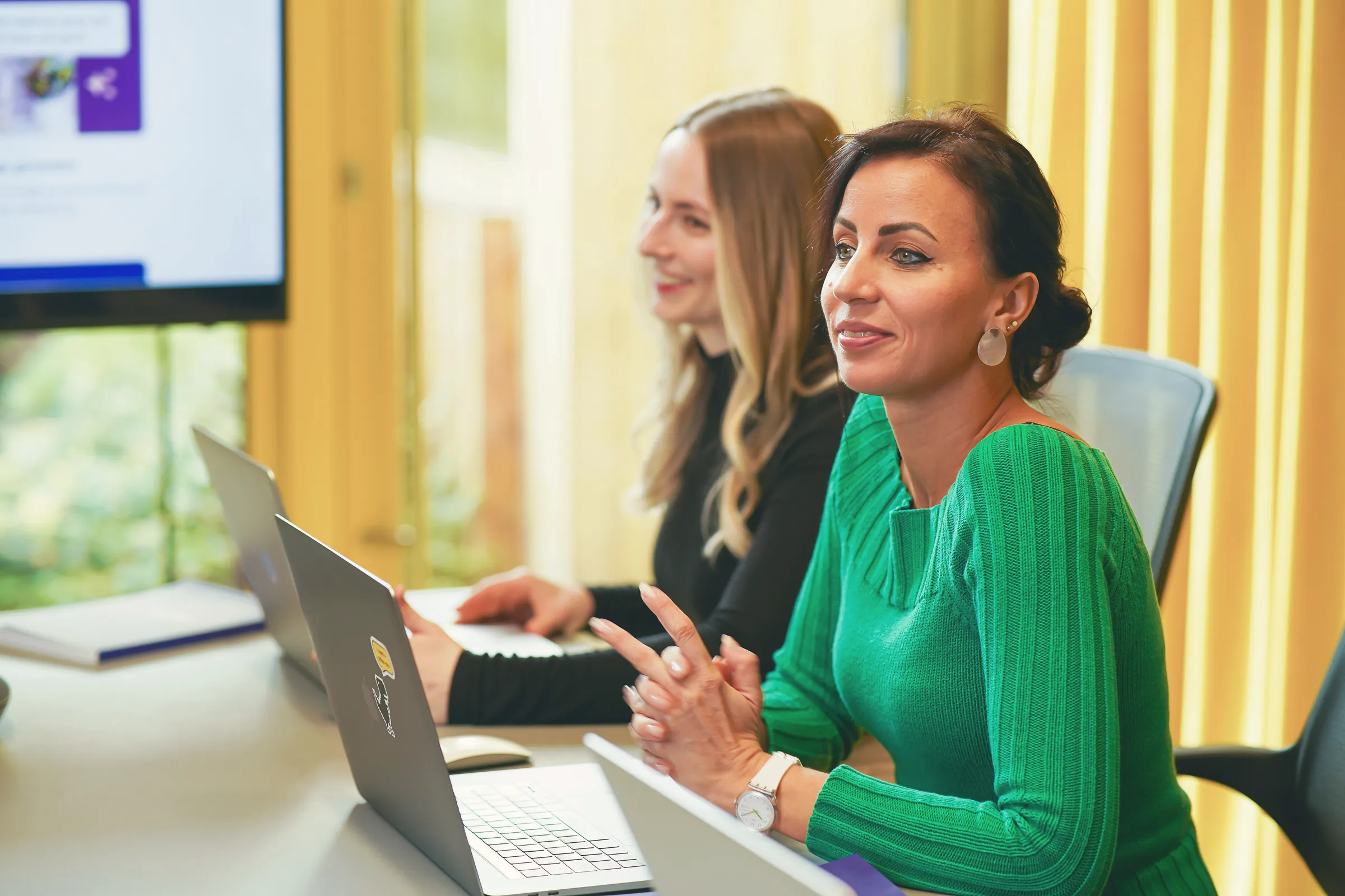Colleagues listening at a meeting table