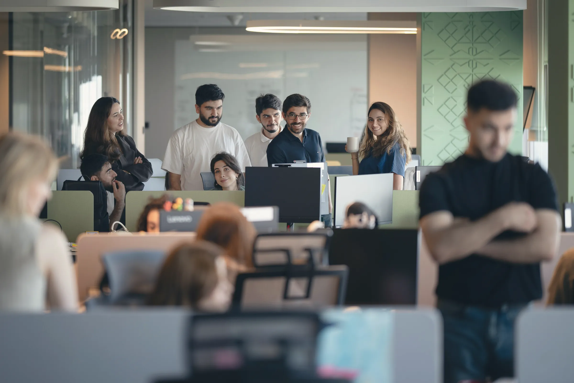 Team gathered in a busy open-plan office