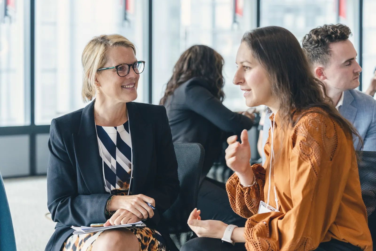 Two attendees talking between sessions at the EVP Summit