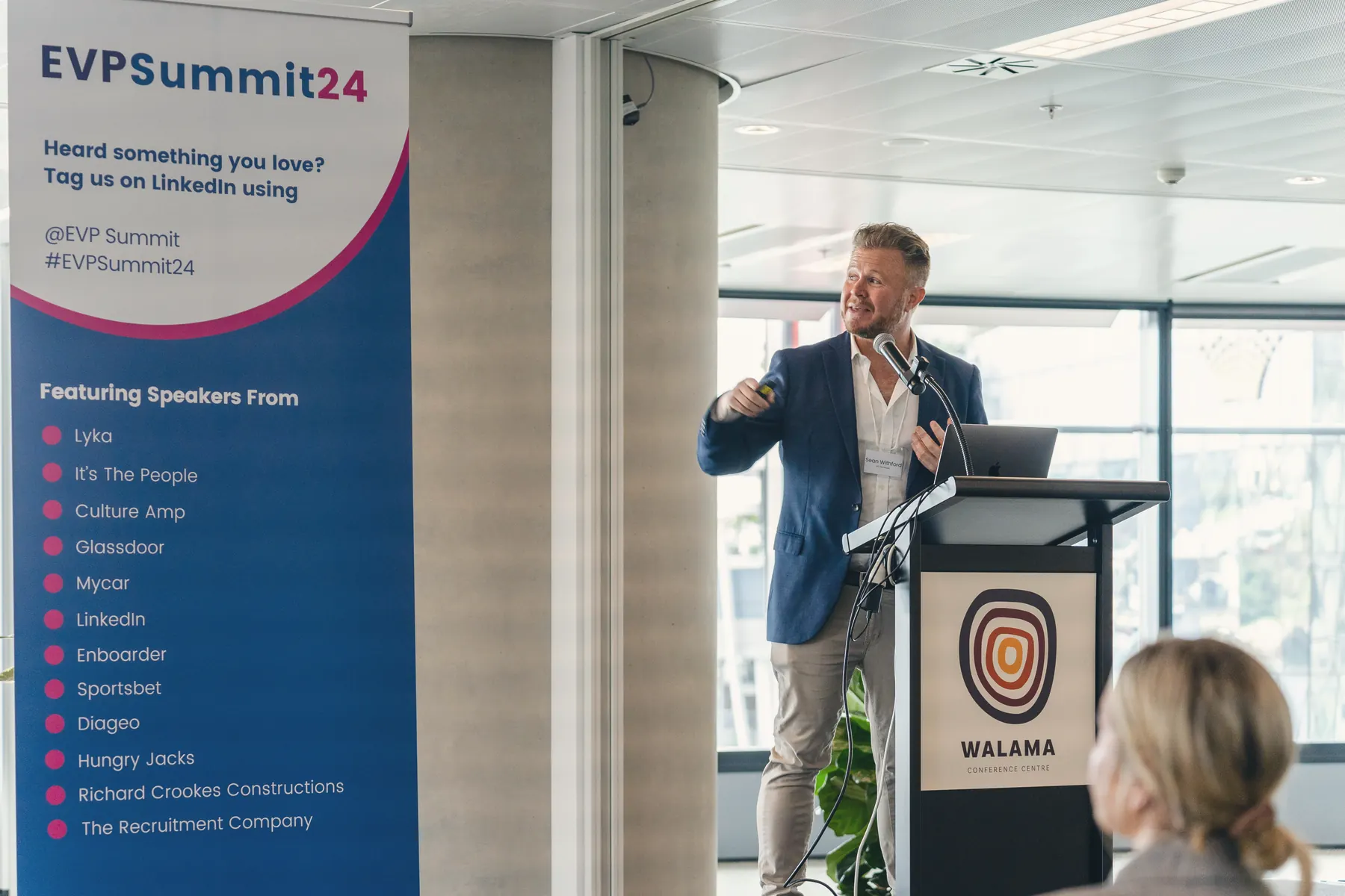 Sean Withford speaking at the lectern at the EVP Summit
