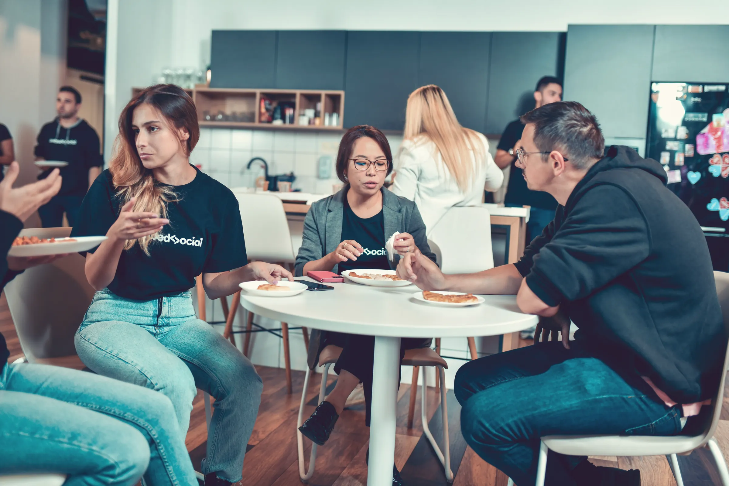Team sharing lunch in the office kitchen