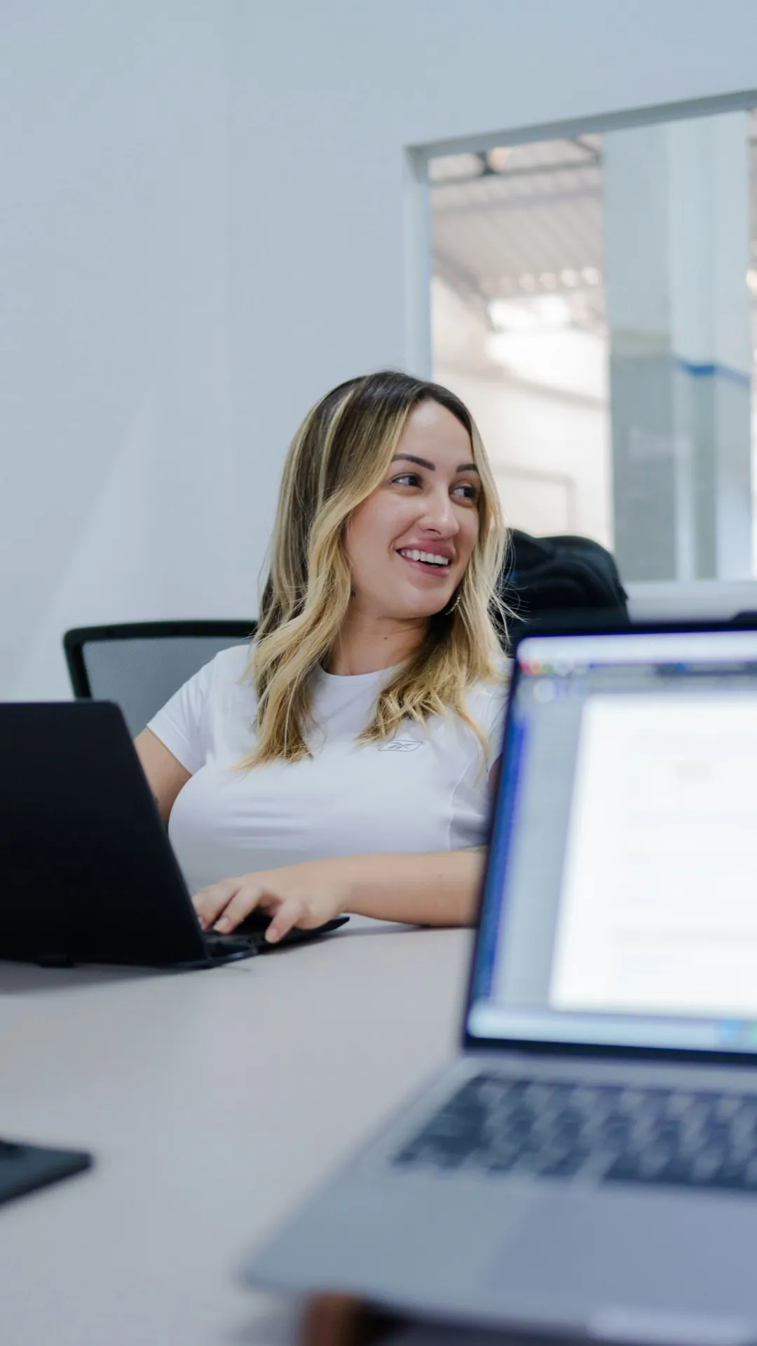 Woman smiling at a meeting table