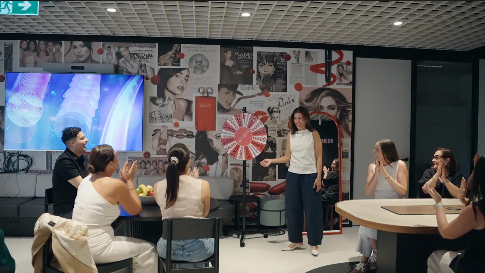 Revlon team gathered for an event in the office breakout space