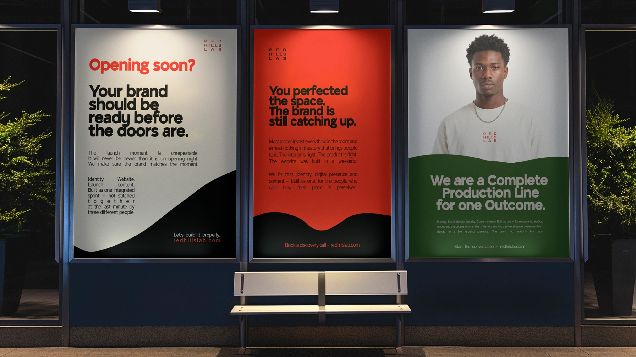 Three backlit posters on a wall: brand readiness, brand catching up, and complete production line with man portrait.