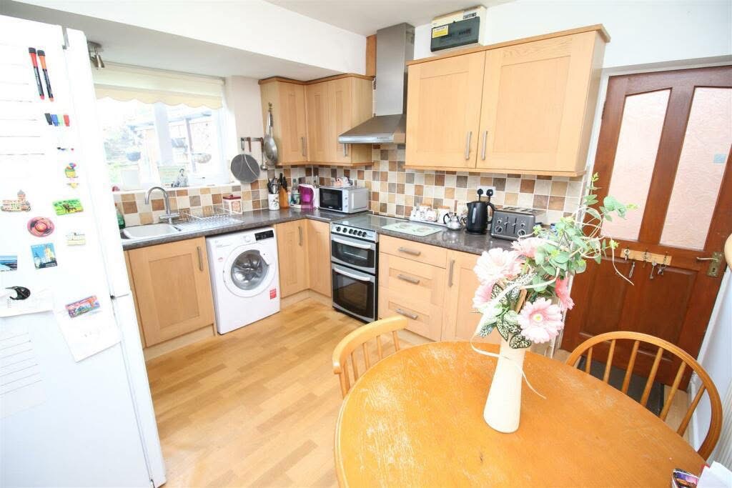 Original wooden cabinets and dark worktops