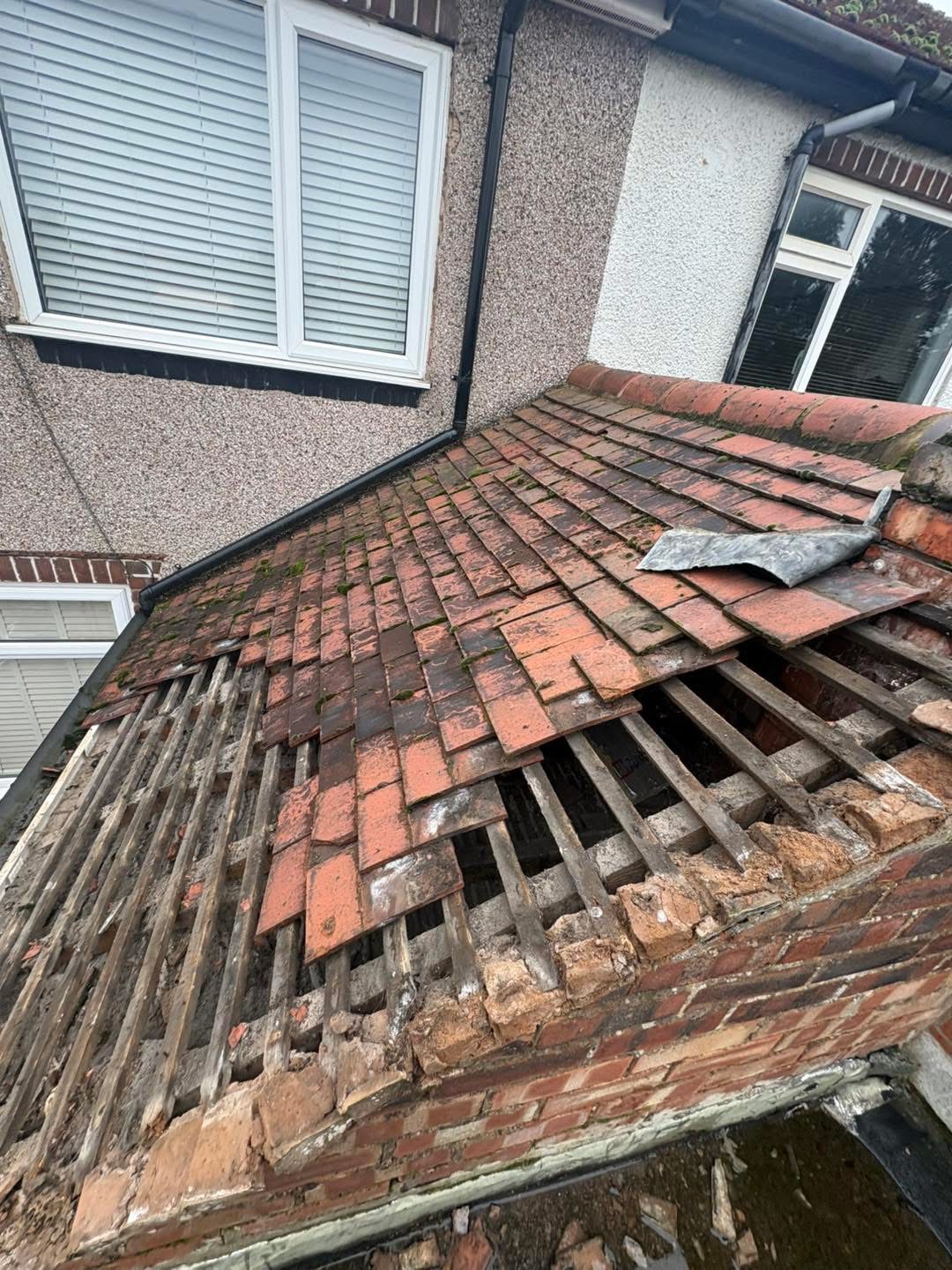 During: the old roof tiles being removed