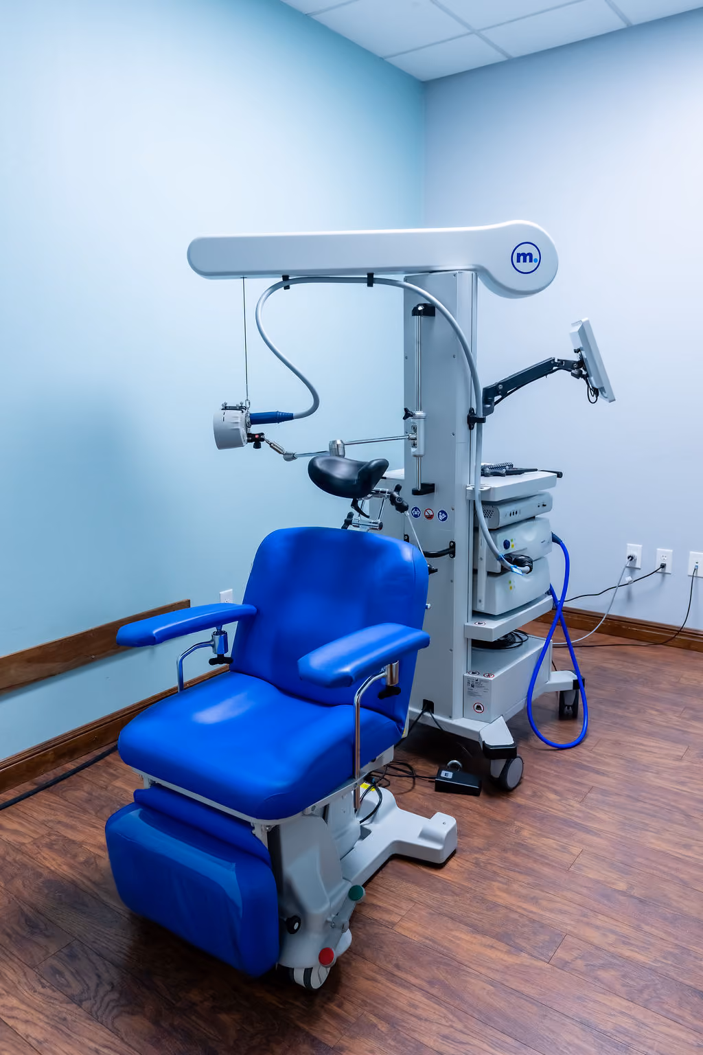 An rTMS treatment chair and magnetic coil in a NeuroBridge treatment room