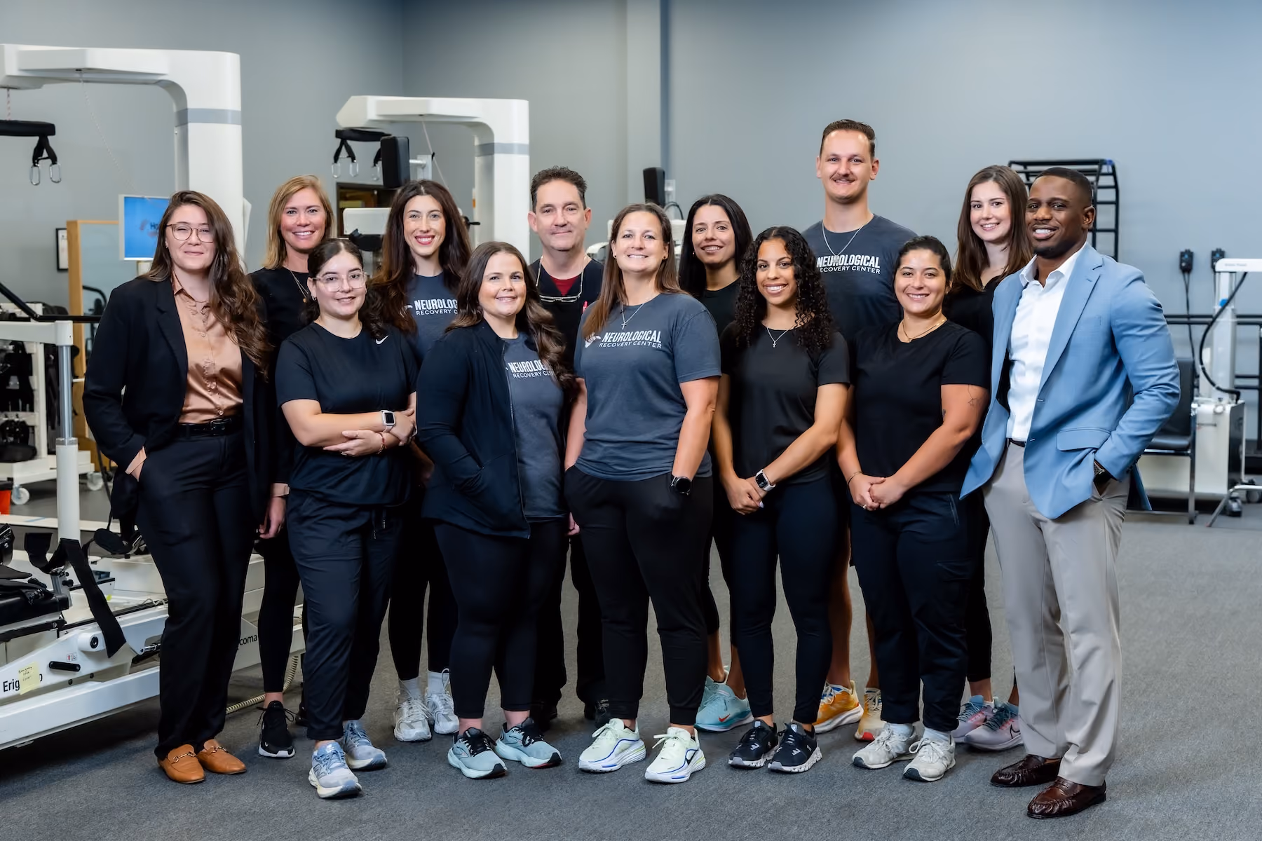 The NeuroBridge care team standing together in the clinic’s rehabilitation gym