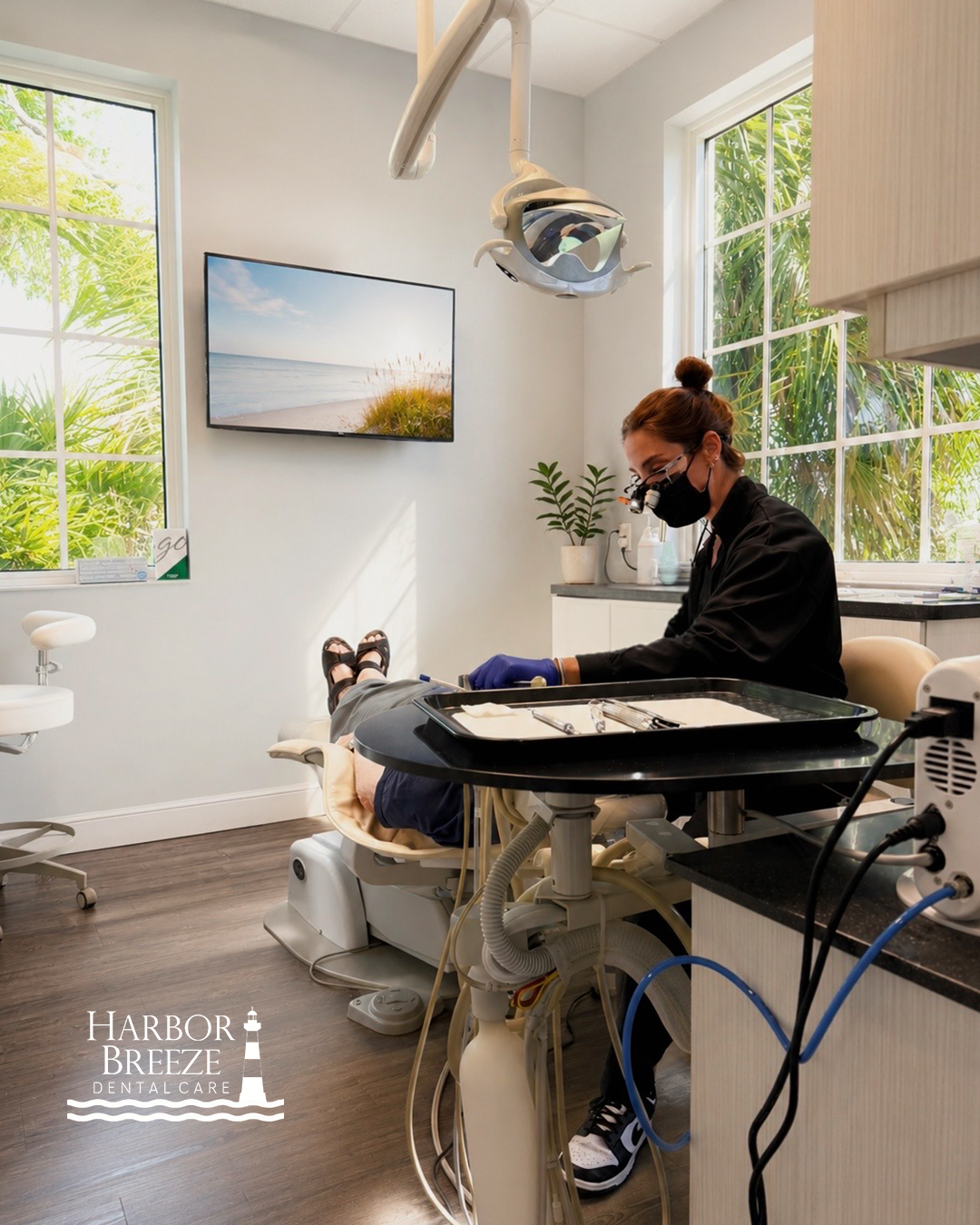 A treatment room at Harbor Breeze Dental Care in Jupiter, Florida, with natural light and a coastal view screen