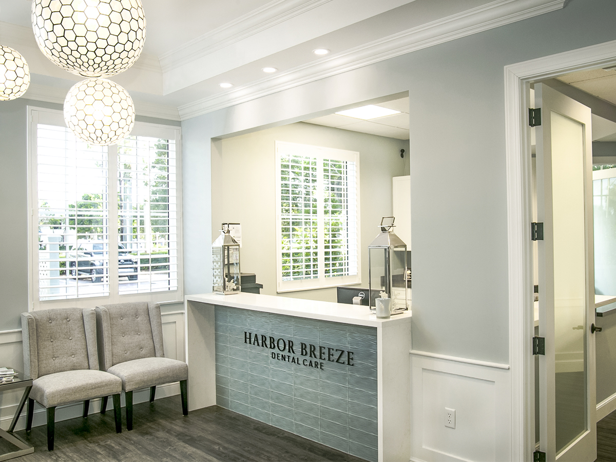 Harbor Breeze Dental Care front desk with teal glass tile in Jupiter, Florida