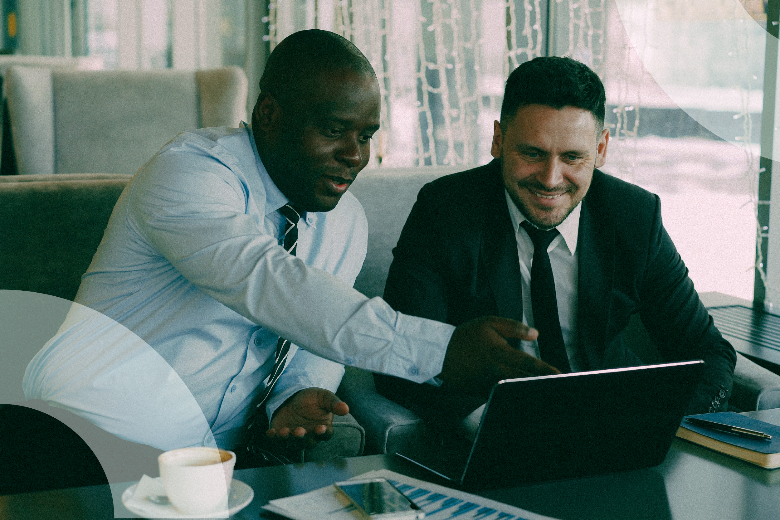 Two executives reviewing a cash forecast on a laptop