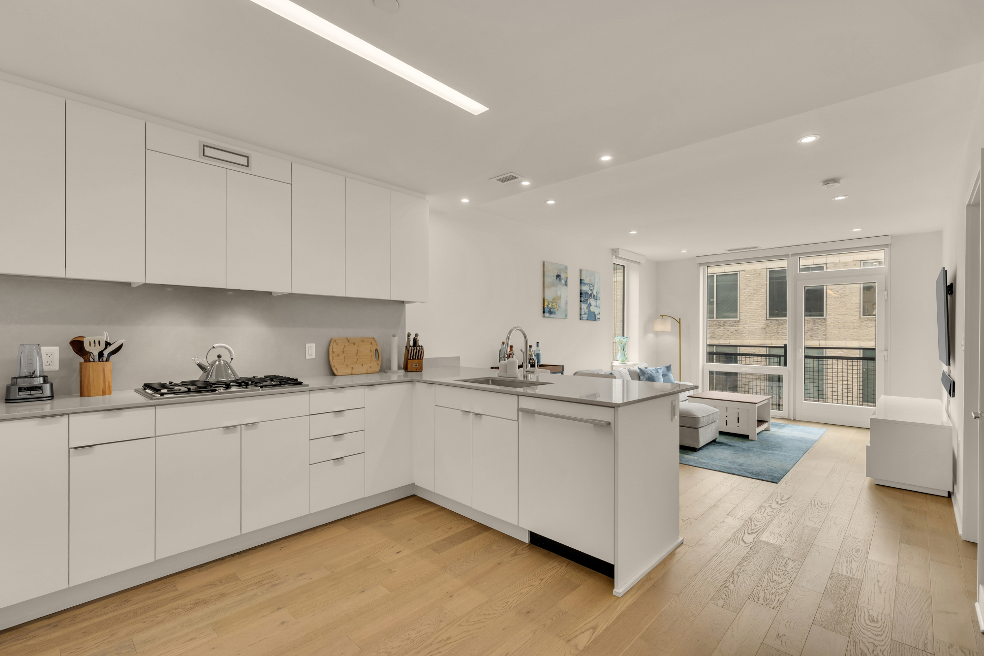 Kitchen, living area, and balcony at Kennedy on L #1105