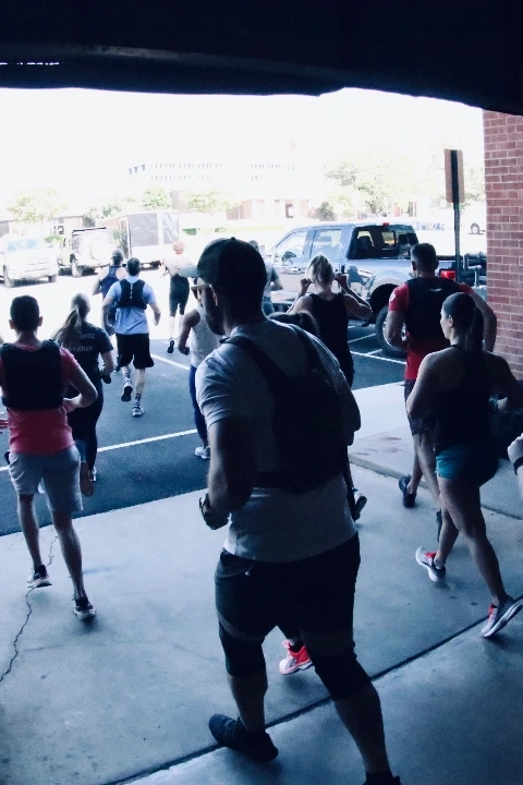 Two members swinging battle ropes during a high-energy workout at CrossFit Fairfax (mobile)