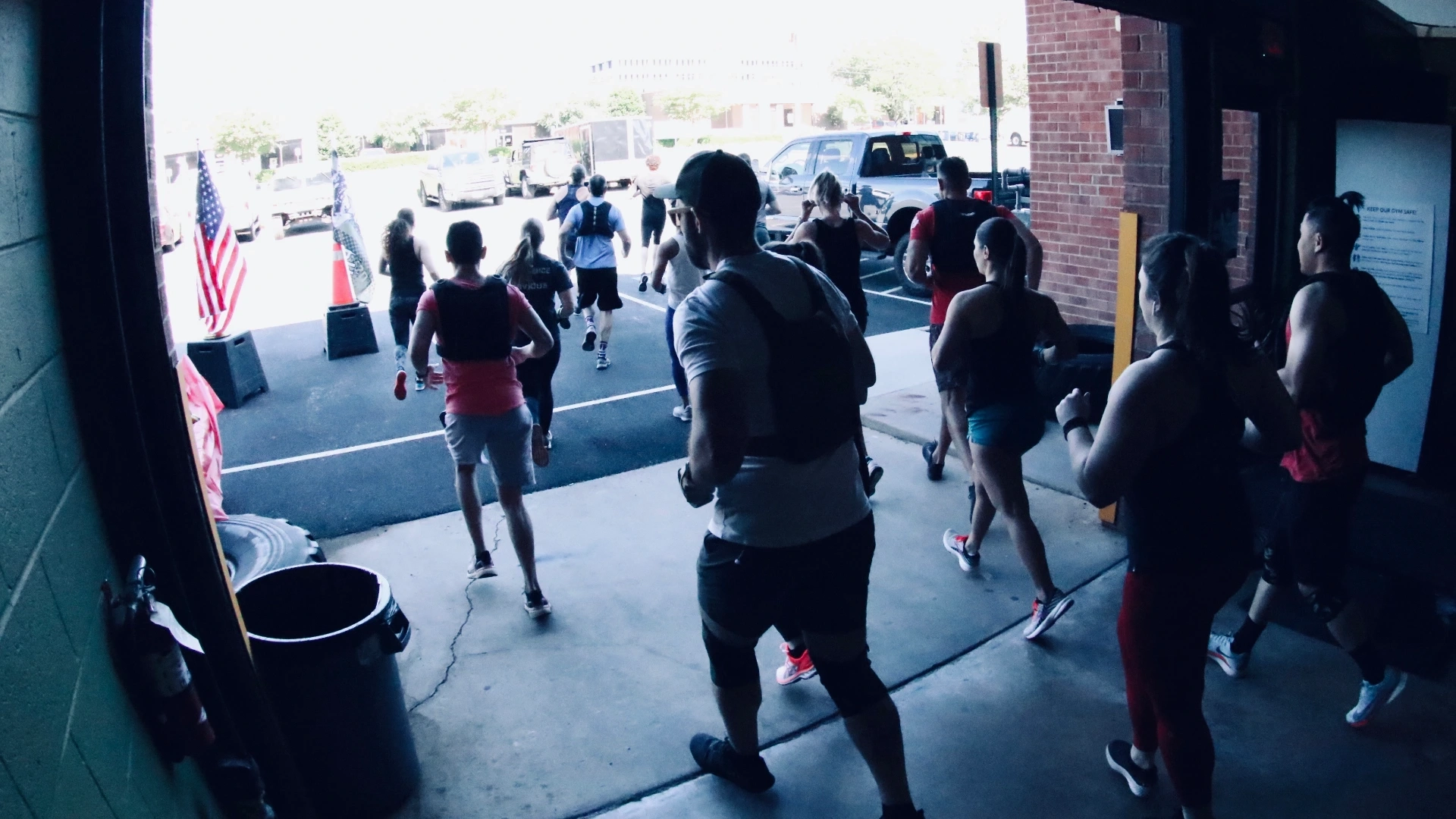 Two members swinging battle ropes during a high-energy workout at CrossFit Fairfax