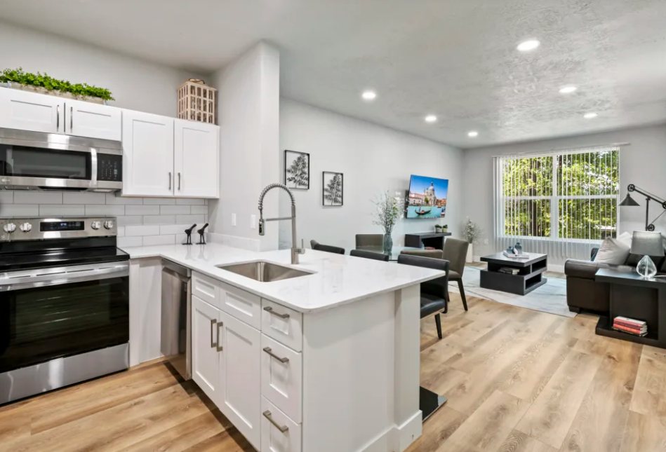 Colonial Court: Renovated unit kitchen and living room with plank flooring