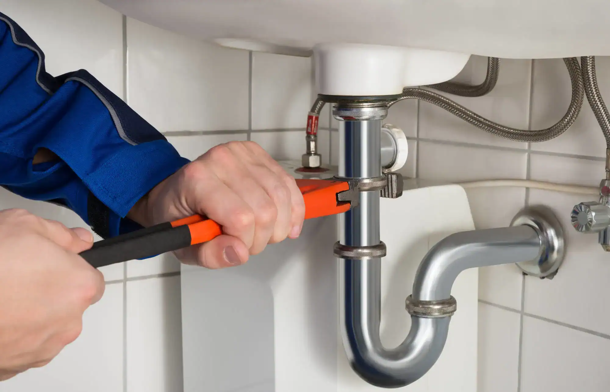 Plumber-Tightening-Bathroom-Sink-Supply-Line-With-Adjustable-Wrench