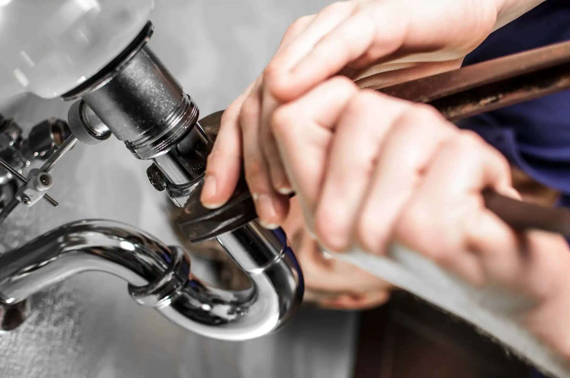 Plumber-Tightening-Sink-Drain-Pipe-Fittings-With-Wrench-Under-Sink|