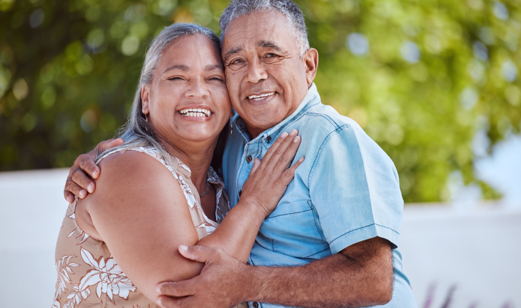 Smiling older couple embracing outdoors