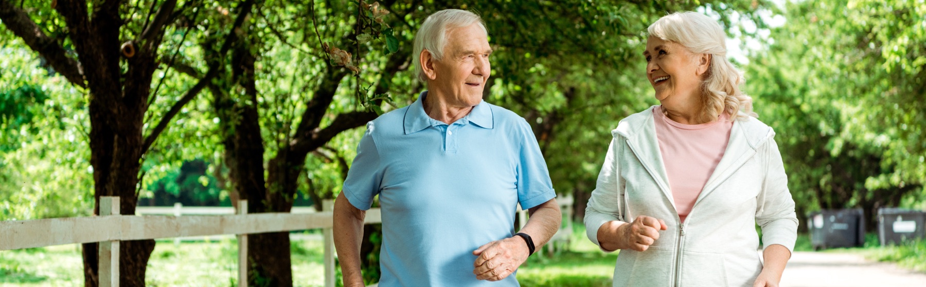 Older couple walking together in a park