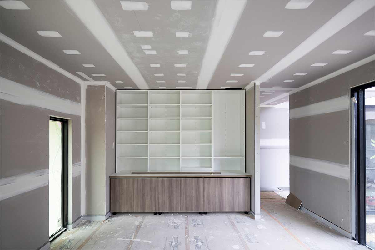 Newly remodeled retail space with drywall, flooring, and office accessories.