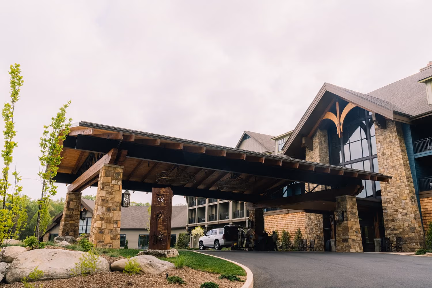 Covered hotel entrance with stone columns and timber roof at a D&S Builders hospitality project in Knoxville