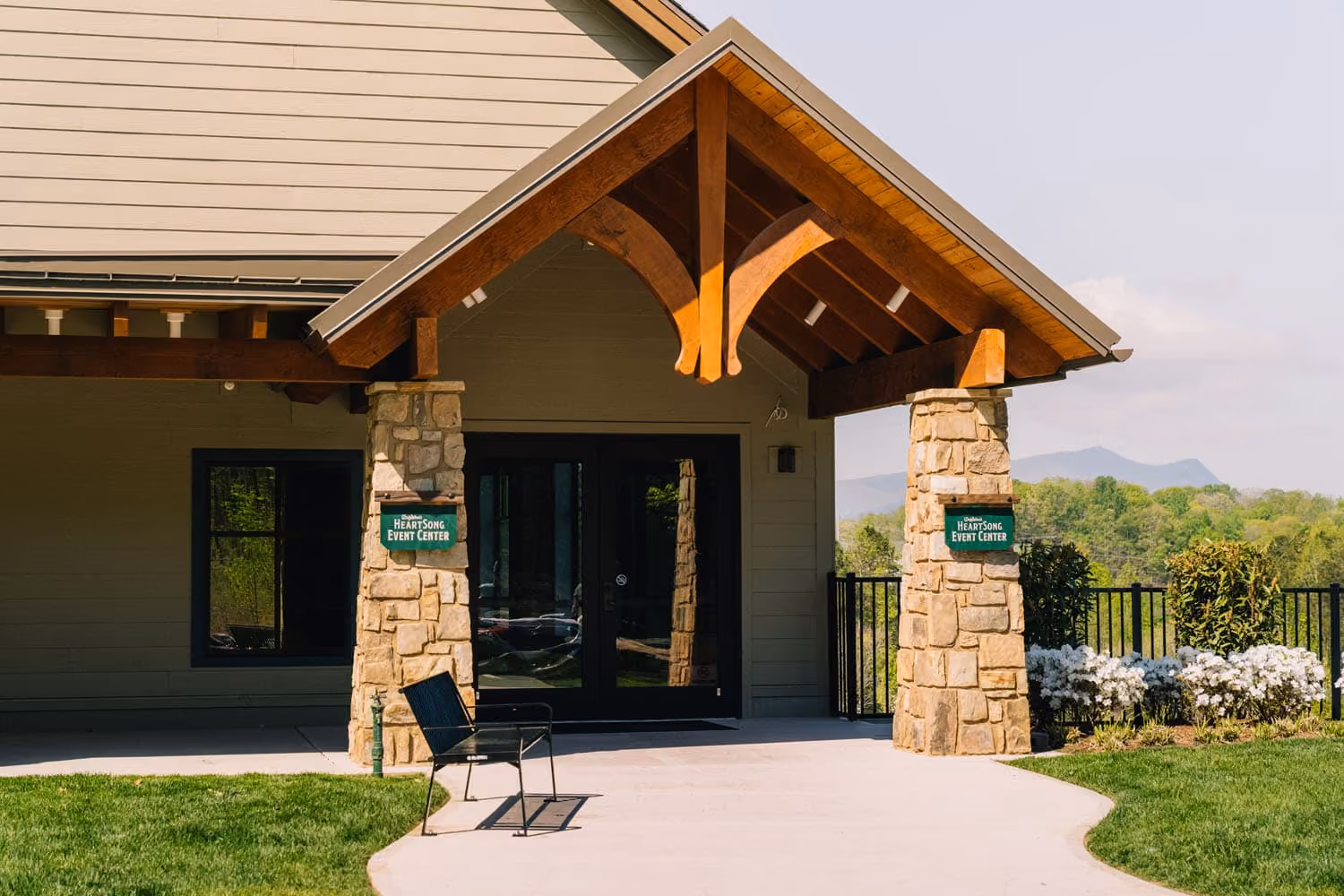 Stone entryway with timber gable roof at a D&S Builders hospitality construction project in Knoxville