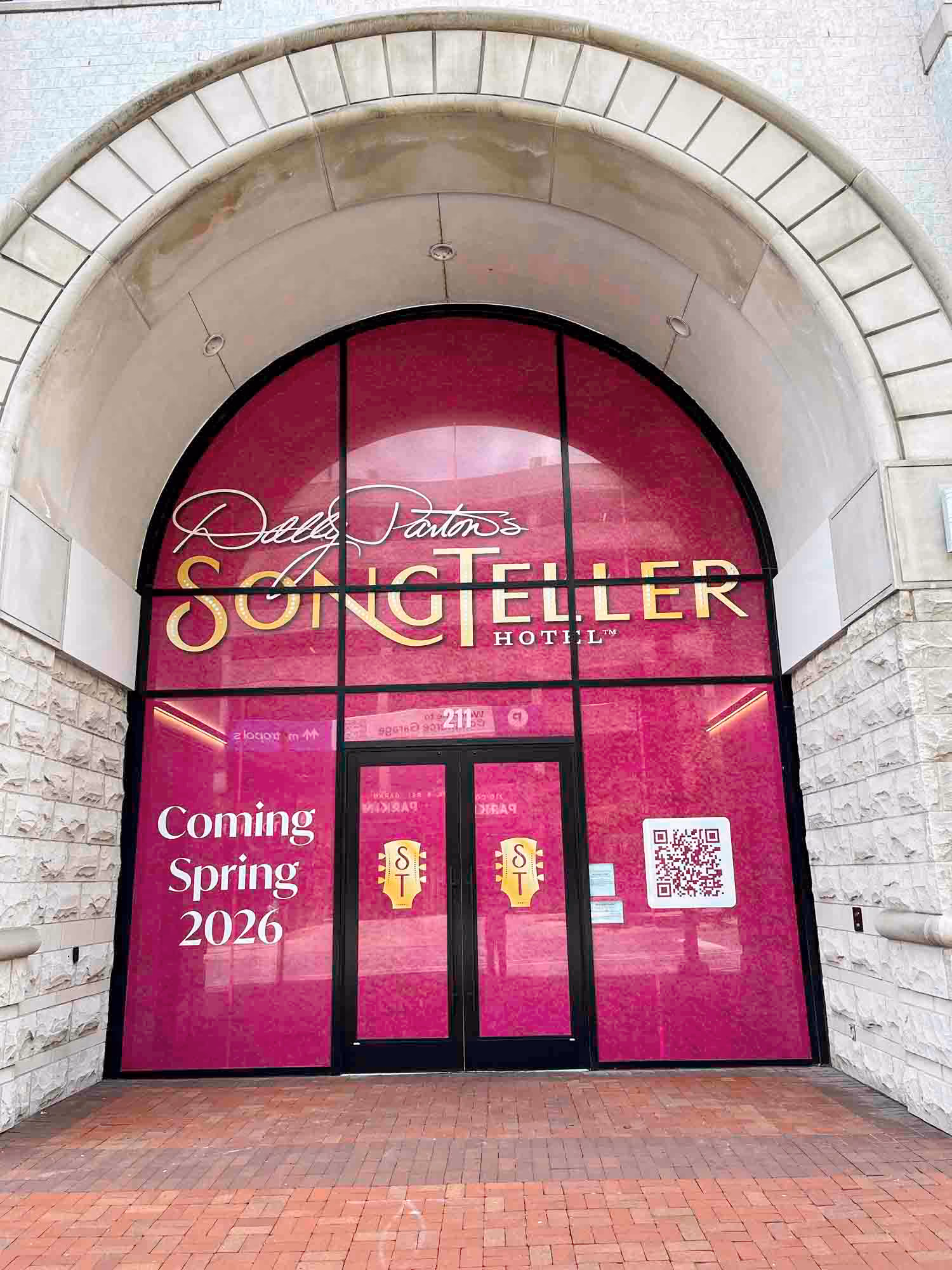 Dolly Parton’s SongTeller Hotel entrance under construction, with a “Coming Spring 2026” sign