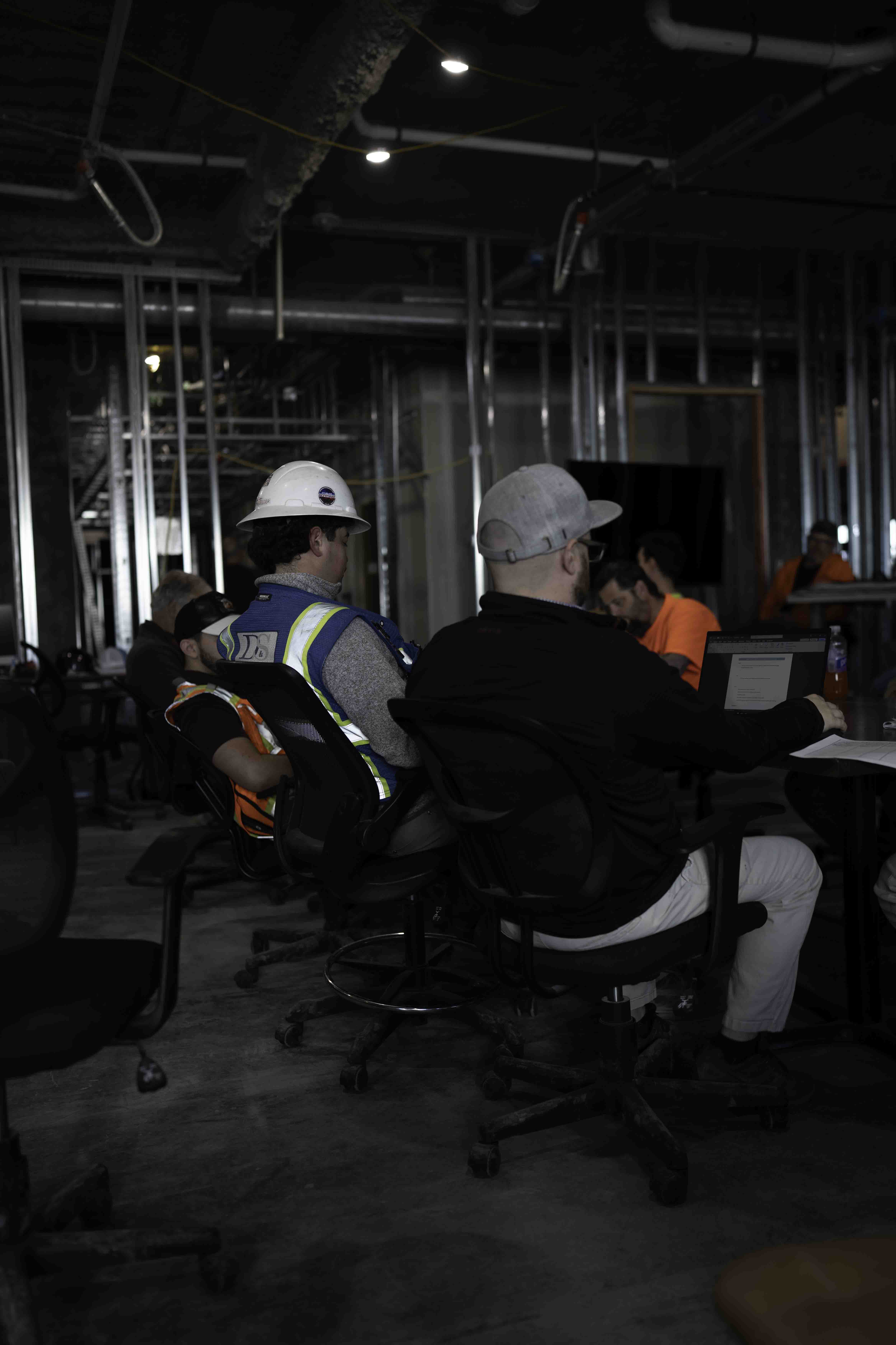 Construction team meeting inside an unfinished building interior