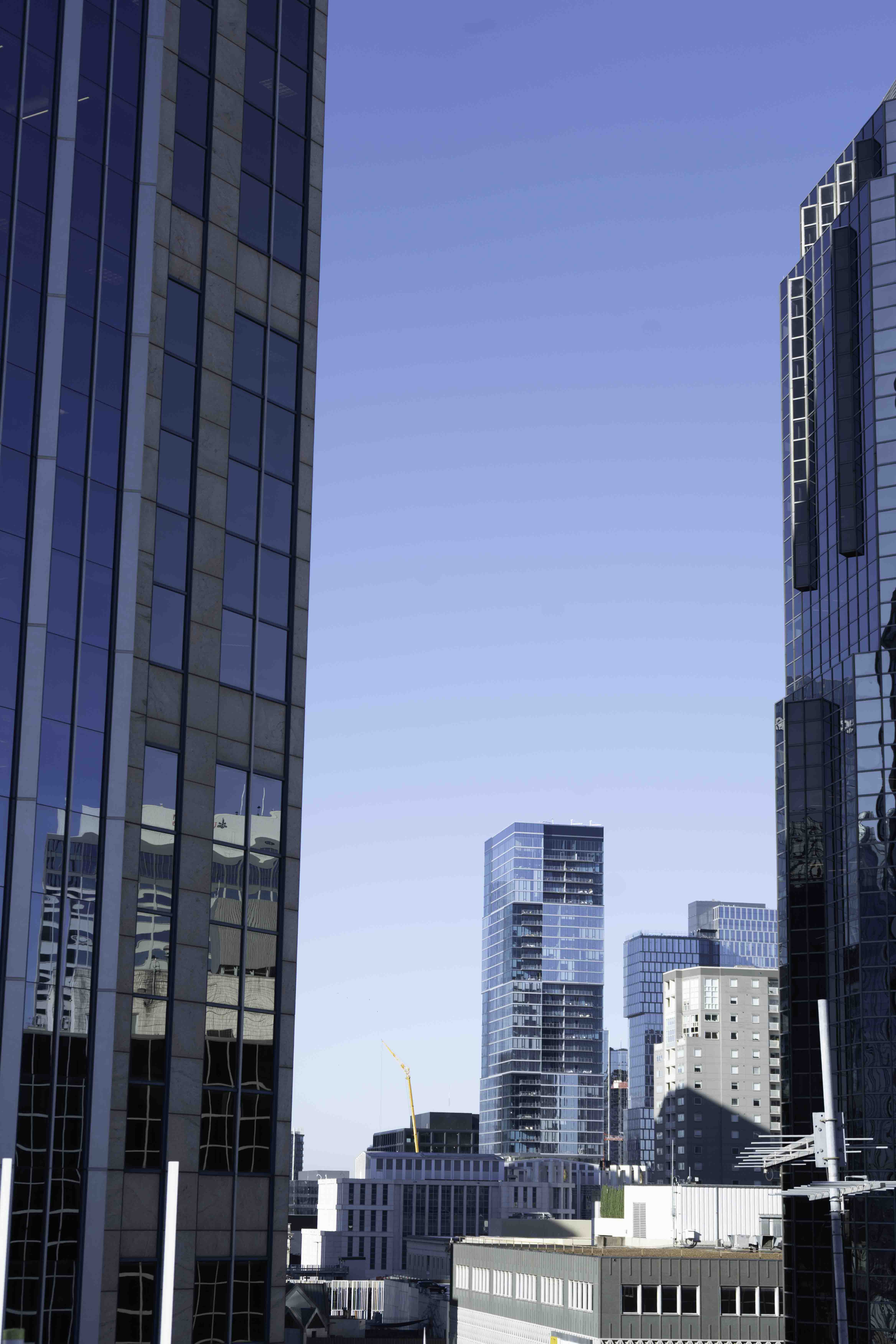 Downtown skyline framed by glass office towers under a clear blue sky