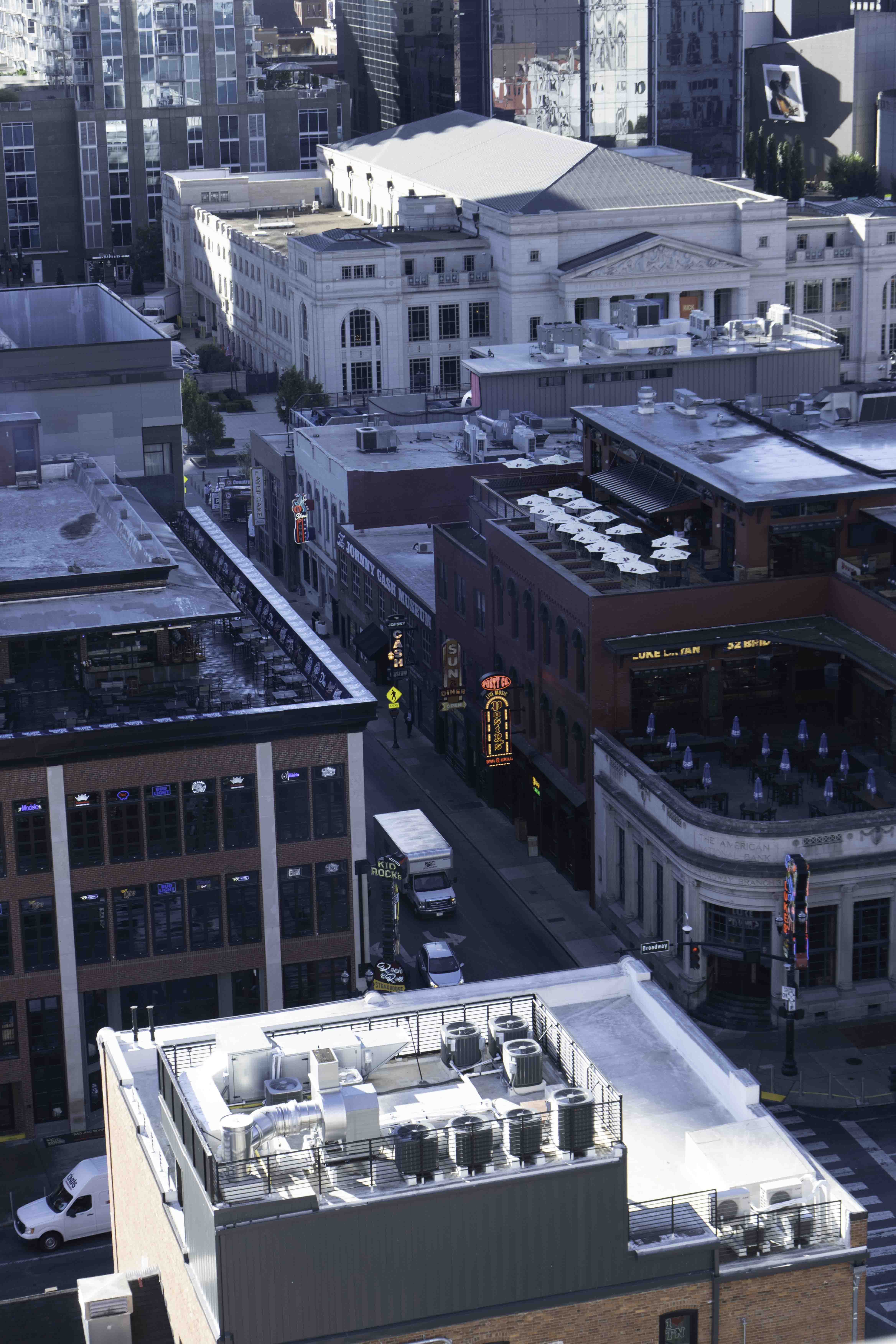 Downtown street with rooftop patios and buildings, viewed from above