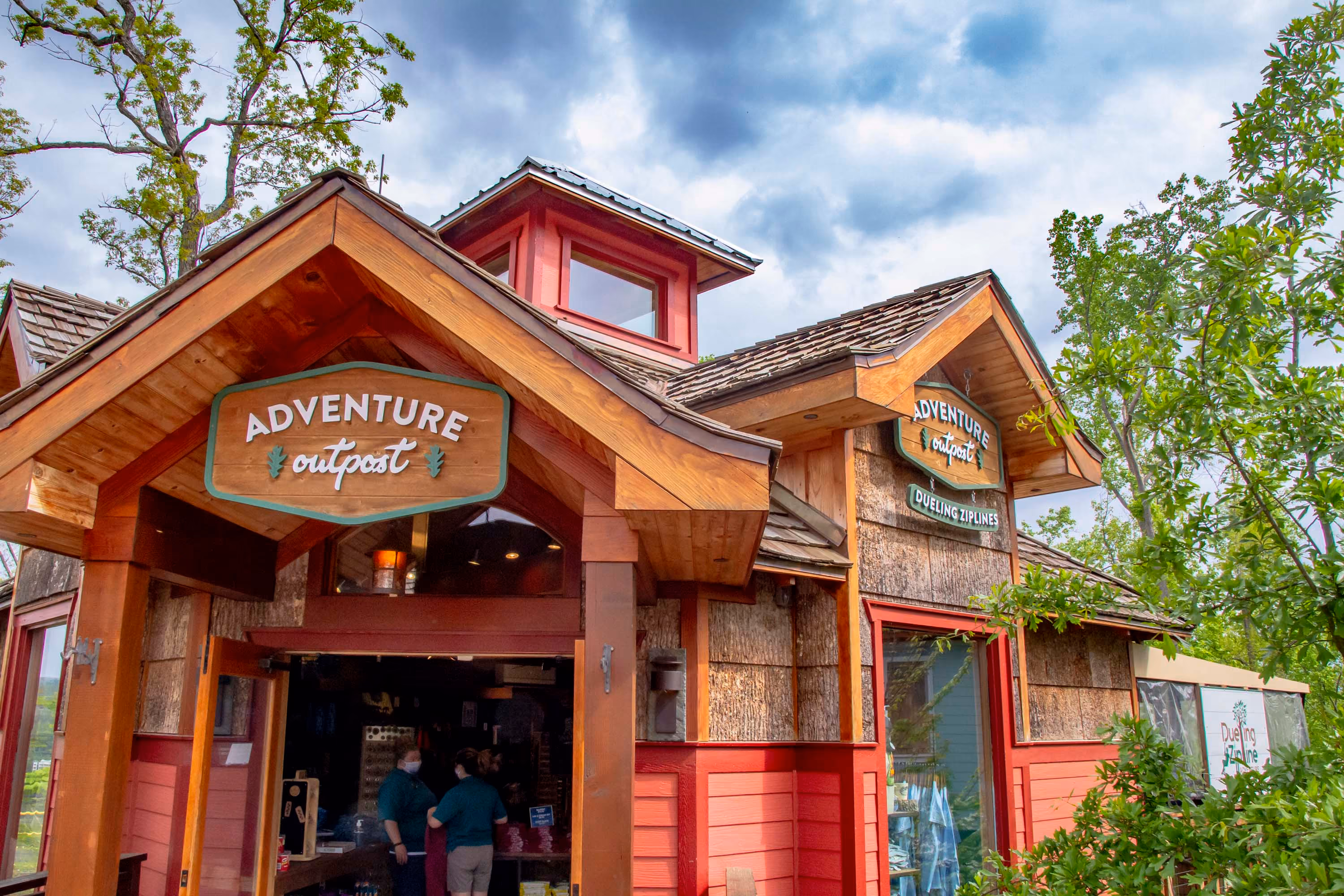 Rustic Adventure Outpost building with wood trim and red siding, likely a hospitality construction project.