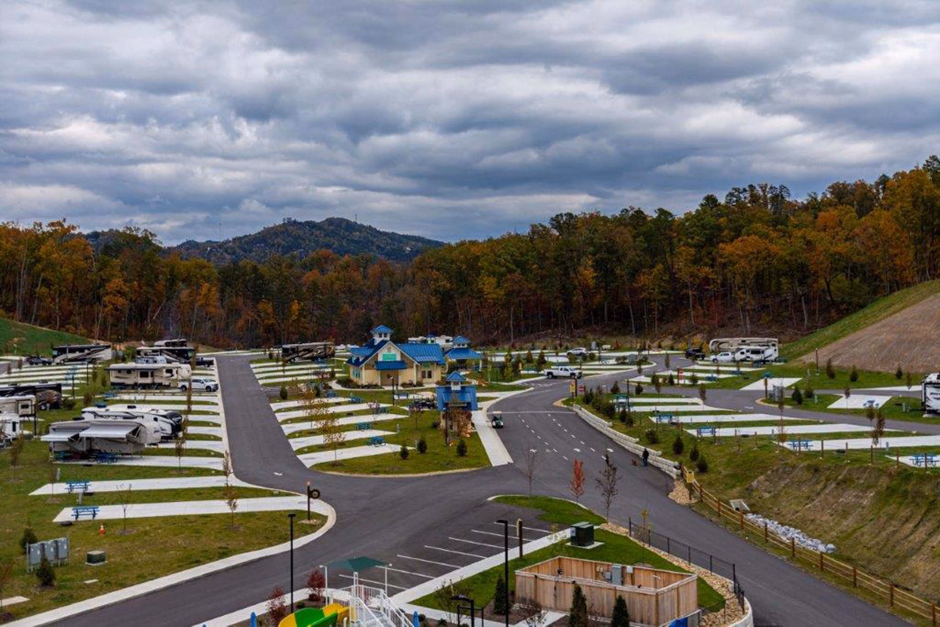 RV park with paved roads, cabins, and mountain views in a wooded setting