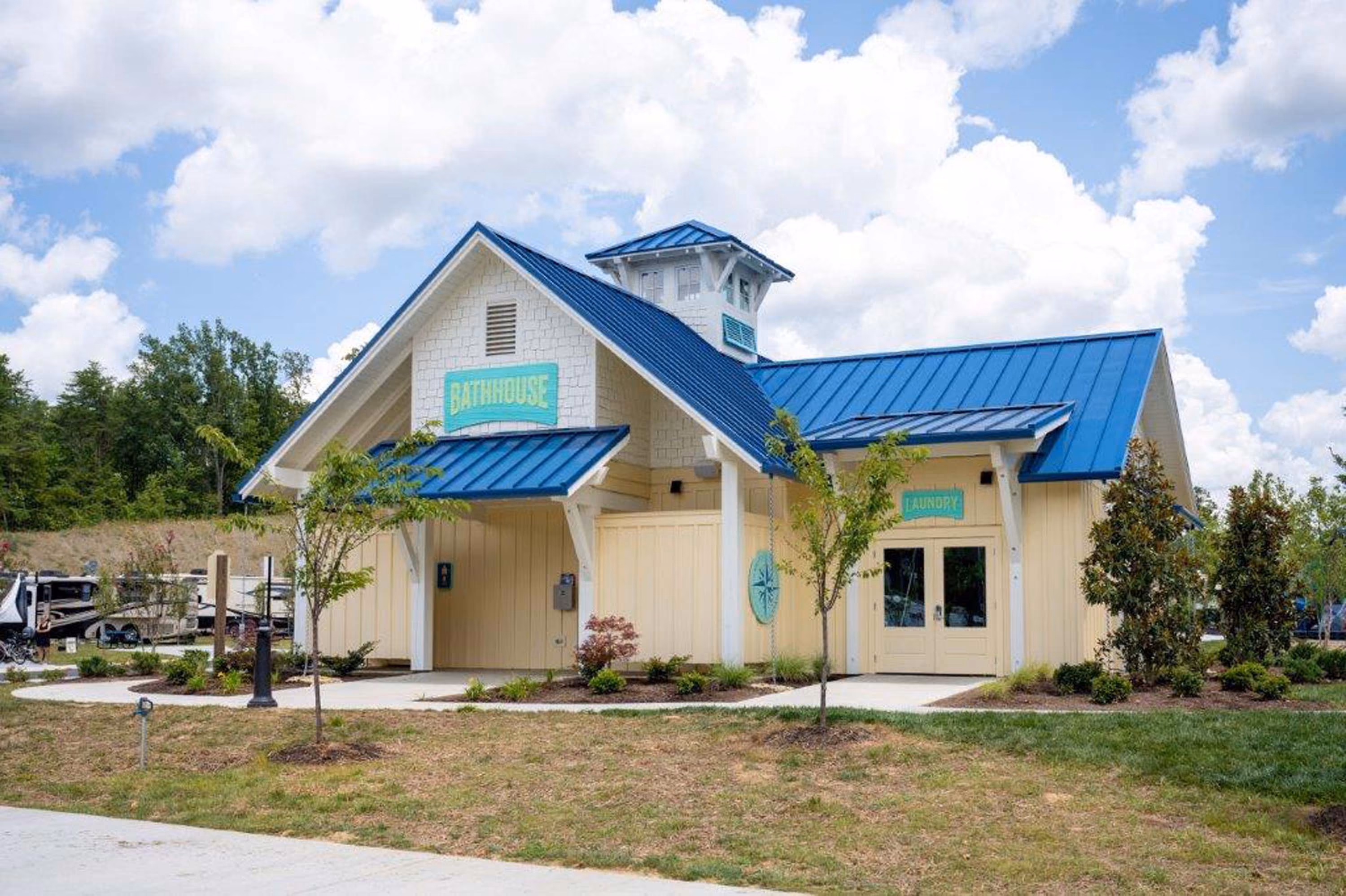 D&S Builders hospitality building with blue metal roof and bathhouse and laundry entrances