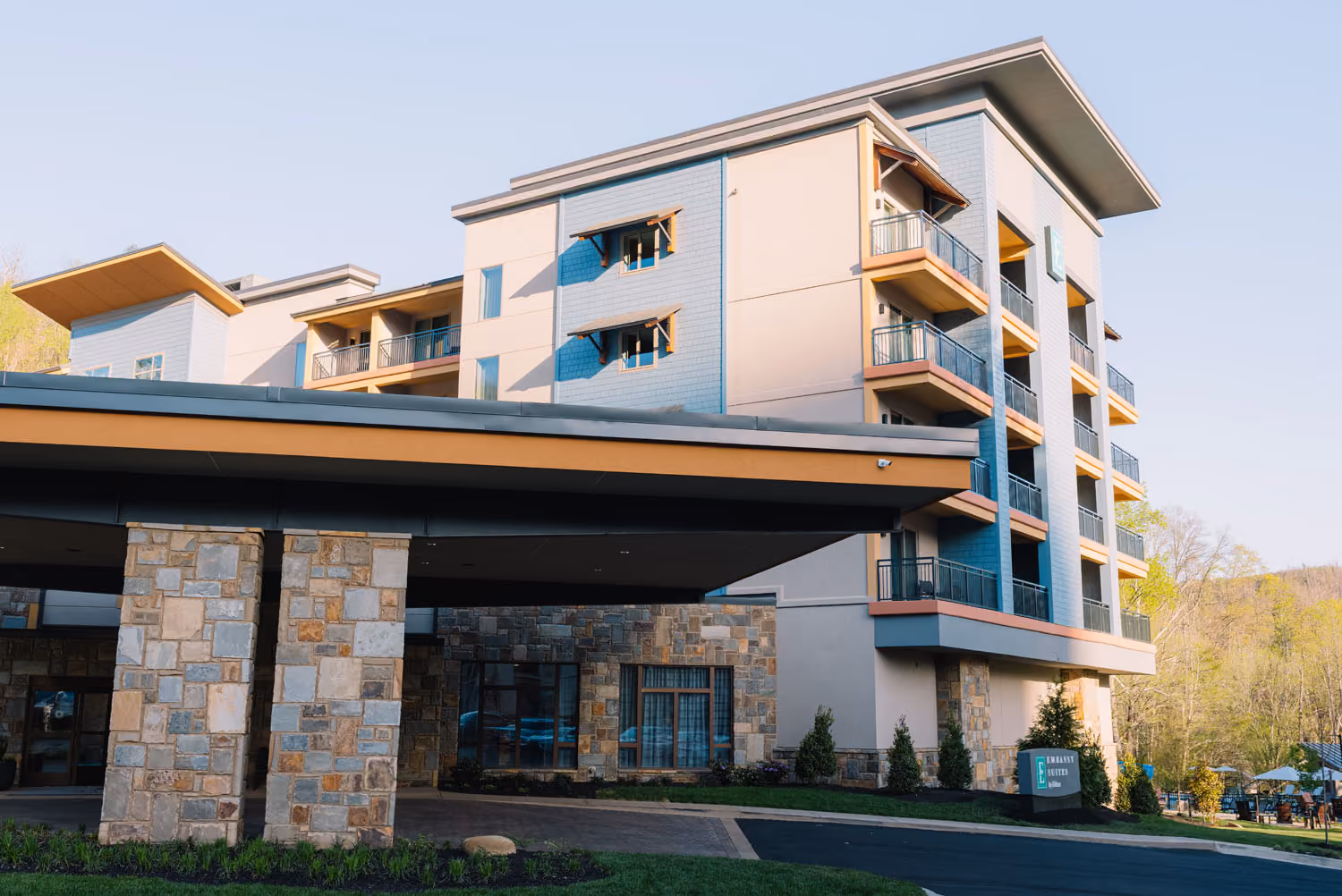 Modern hotel building with stone columns and balconies, likely a hospitality construction project by D&S Builders