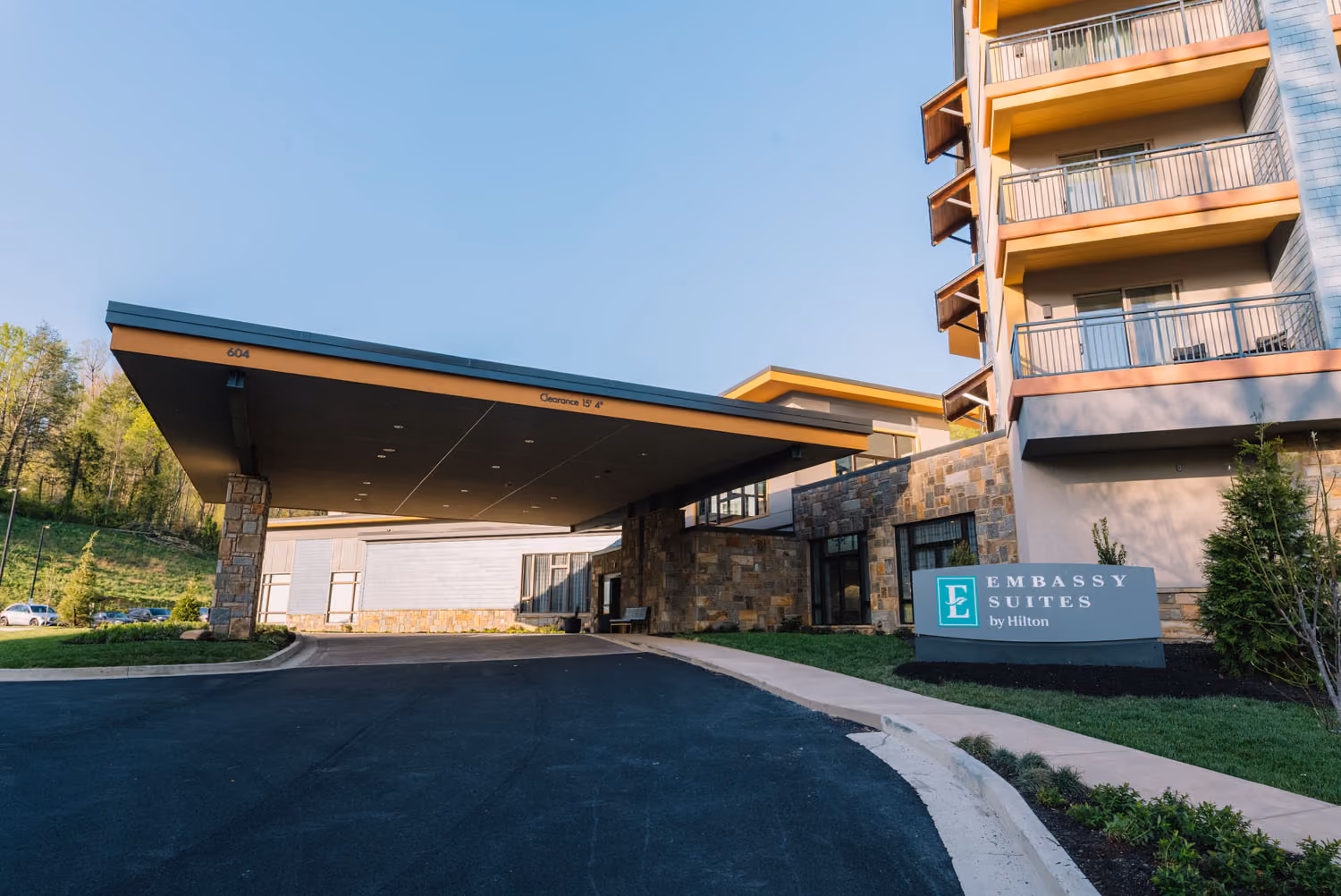 Embassy Suites by Hilton hotel entrance with covered drive-through and balconies